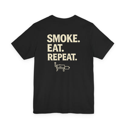 Smoke Eat Repeat BBQ shirt with offset smoker icon on black Bella Canvas 3001 t-shirt